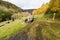 Ruined lead mine buildings with dam in distance