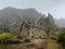 Ruined local storehouse nestled into incredible scenery with steep mountain rocks and vertical peaks. Trekkingtrail on