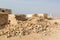 Ruined old Arab pearling and fishing town Al Jumail, Qatar. Pile of stones. The desert at coast of Persian Gulf.