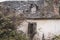 Ruined old house in abandoned garden. Ancient rural architecture in France. Destroyed building with plants on the roof.