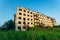 Ruined overgrown sanatorium with bullet marks, consequences of war in Abkhazia