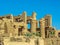 Ruined pillars of the temple complex at Karnak near Luxor, Egypt silhouetted against a blue sky