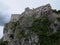 The ruined ruins of Beckov Castle stand on a steep 50 m high cliff in the village of Beckov near the river VÃ¡h