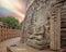 A ruined statue of Gautam Buddha placed beside one of the stupas at Sanchi
