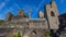 Ruined stone brick walls, towers with a blue sky in the background