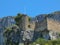 Ruined stone fortified castle on a rock dominating the village of Fontaine de Vaucluse in Provence in southern France