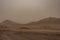 Ruined village near sahara Erg Chebbi dune in sand storm. Moroc