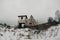 Ruins of an abandoned old church in the melancholic cold field