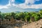 Ruins of an ancient amphitheater against the background of mountains. Majestic mountains and clouds