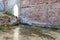 The ruins of an ancient brick building flooded with water