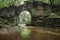 Ruins of an ancient bridge in the forest