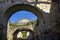 Ruins of ancient building against blue sky. Collapsed ceiling. Masonry, room with arched vaults in christian church.