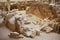 Ruins of the ancient buildings and decorated pottery from the Minoan Bronze Age at the archaeological site in Akrotiri, Greece.