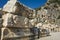 Ruins of ancient city of Myra in Demre, Turkey. Theatrical masks and faces relief and ancient rock tombs