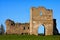 Ruins of an ancient Krements castle. Part of the defensive wall and castle tower against blue sky. Scenic spring sunset