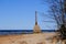 Ruins of the ancient Kurmrags lighthouse on the shore of the Gulf of Riga. Stone masonry in the lower part of the