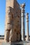 The ruins of ancient Persepolis. A bull statue and columns. details of the gate of all nations