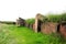 The ruins of an ancient sanctuary with the remains of walls and menhirs lying in the steppe tied with ritual ribbons