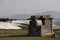 Ruins of ancient tomb in Hierapolis with white travertine terraces of Pamukkale on background