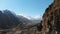The ruins of ancient towers on a rock in the mountains of Upper Balkaria. Aerial view of the gorge with a dirt road and