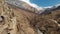 The ruins of ancient towers on a rock in the mountains of Upper Balkaria. Aerial view of the gorge with a dirt road and