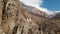 The ruins of ancient towers on a rock in the mountains of Upper Balkaria. Aerial view of the gorge with a dirt road and