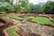 Ruins of ancient town under Sigiriya rock, Sri Lanka. Park with trees and archeological area. UNESCO world heritage site