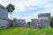 Ruins of ancient Tulum. Architecture of ancient maya. View with temple and other old buildings, houses. Blue sky and lush greenery