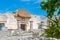 Ruins of ancient Tulum. Architecture of ancient maya. View with temple and other old buildings, houses. Blue sky and lush greenery