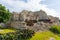 Ruins of ancient Tulum. Architecture of ancient maya. View with temple and other old buildings, houses. Blue sky and lush greenery