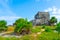 Ruins of ancient Tulum. Architecture of ancient maya. View with temple and other old buildings, houses. Blue sky and lush greenery