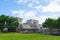 Ruins of ancient Tulum. Architecture of ancient maya. View with temple and other old buildings, houses. Blue sky and lush greenery