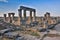 Ruins of Appollo temple with fortress at back in ancient Corinth, Peloponnese, Greece