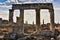 Ruins of Appollo temple with fortress at back in ancient Corinth, Peloponnese, Greece