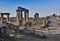 Ruins of Appollo temple with fortress at back in ancient Corinth, Peloponnese, Greece