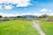 Ruins of the architecturally significant Mesoamerican pyramids and green grassland located at at Teotihuacan, an ancient