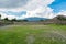 Ruins of the architecturally significant Mesoamerican pyramids and green grassland located at at Teotihuacan, an ancient