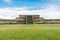 Ruins of the architecturally significant Mesoamerican pyramids and green grassland located at at Teotihuacan, an ancient