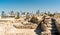 Ruins of Bahrain Fort with skyline of Manama. A UNESCO World Heritage Site