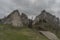 Ruins of castle Vrsatec in spring dark cloudy day with path and poles