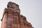 Ruins and columns in the ancient Qutub Minar complex in New Delhi India, a world heritage site