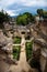 Ruins in Hermano Pedro with garden and dramatic sky, Antigua, Guatemala