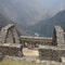 Ruins of an inca building at the top of Waynapicchu mountain, gray stone walls