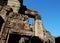 The ruins of medieval Khmer buildings. Fragments of decorative stone carving