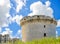 Ruins of medieval old tower of castle under blue sky with cloud