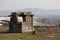 Ruins of an old ancient abandoned stone tomb in Hierapolis, Turkey with white Pamukkale white mineral travertine terrace formation