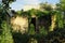 Ruins of an old brown brick house with an empty entrance