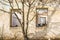 The ruins of an old earthen house without a roof. Holes in the wall at the site of windows and doors