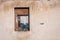 The ruins of an old earthen house without a roof. Holes in the wall at the site of windows and doors