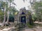 The ruins of an old Khmer temple are hidden among the trees of a dense forest